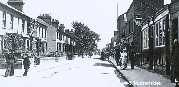 A lady walking down Mill Road in Cambridge wearing a large hat